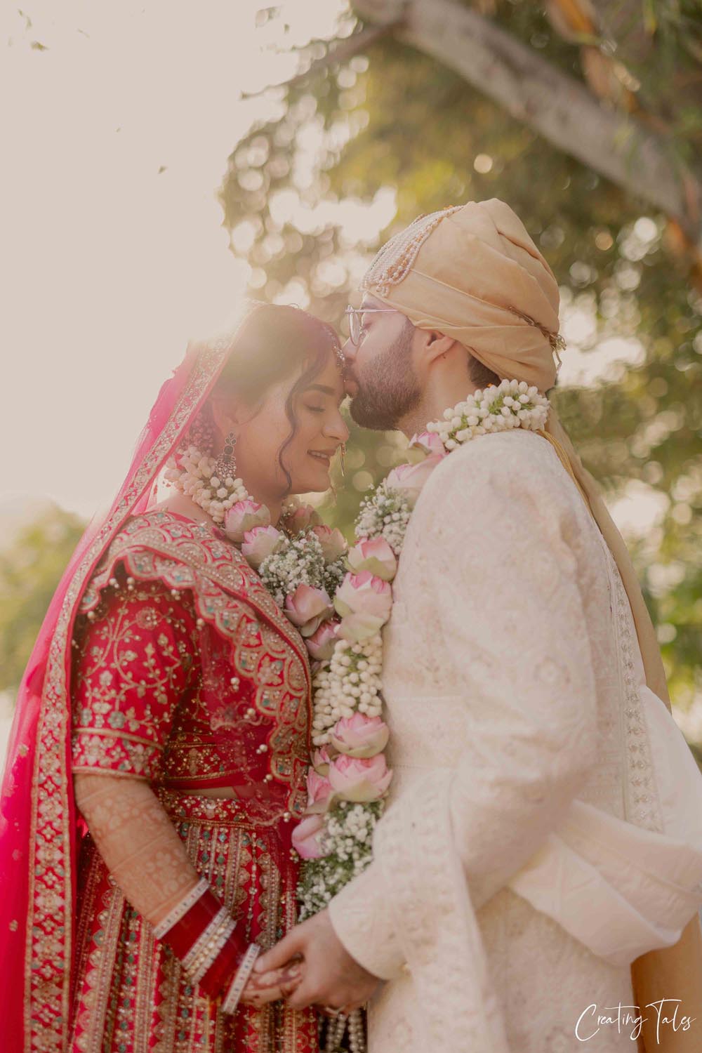 A stylishly dressed couple sitting together in a warmly lit, modern interior