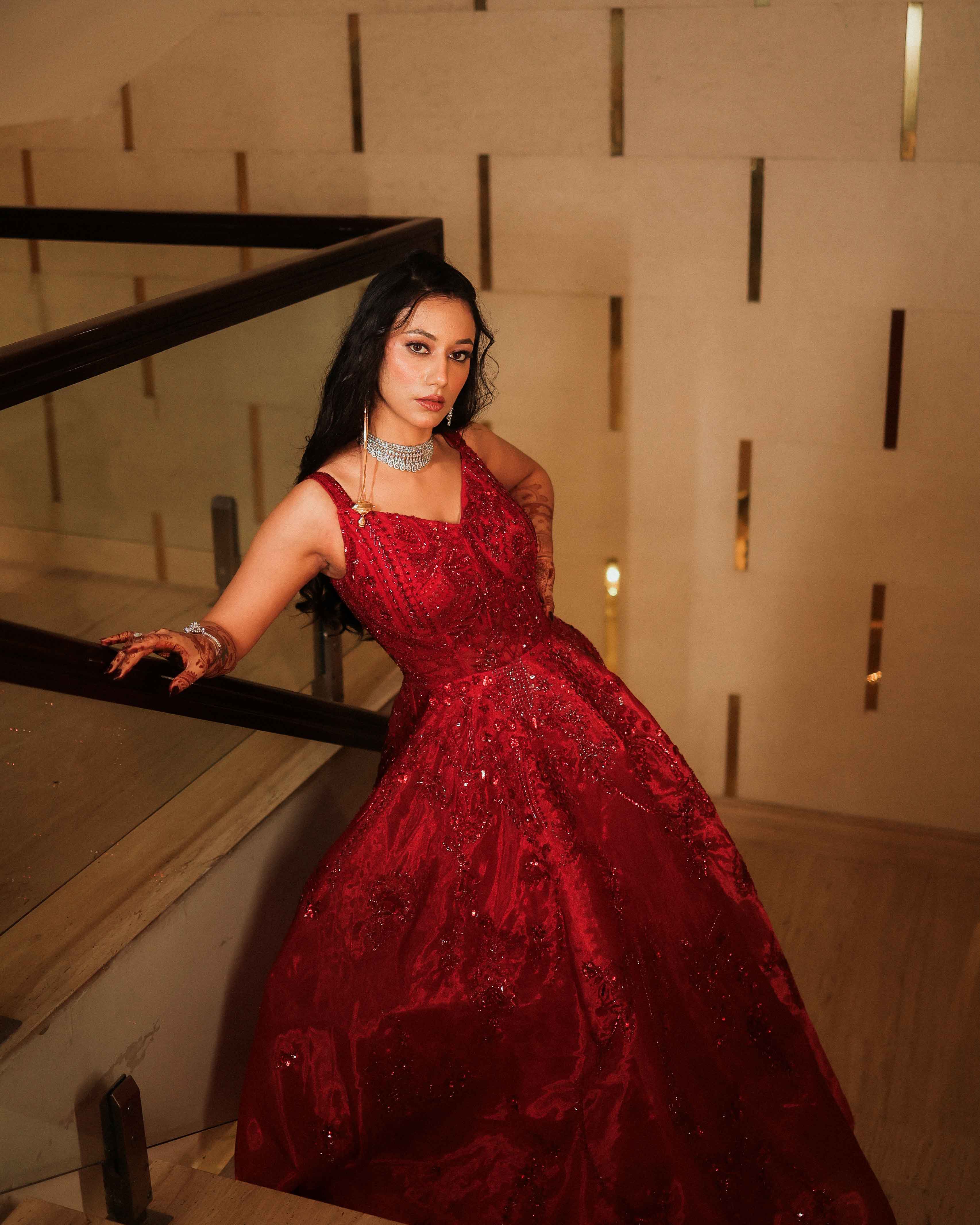 A couple in elegant black outfits standing in a desert landscape at dusk